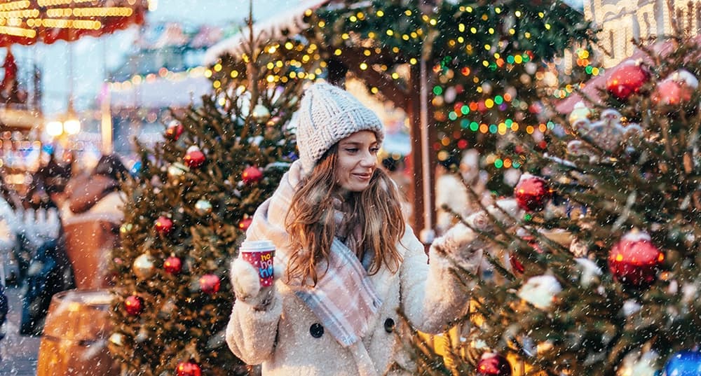 Girl walking on Christmas Market on Red Square in Moscow.