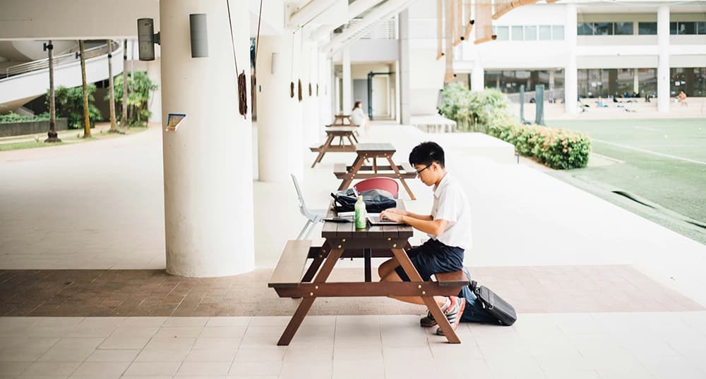 A boy working on his studies at uni.