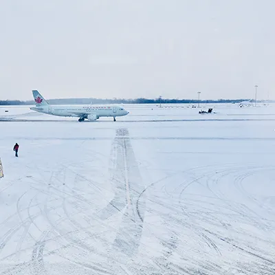 Air Canada snowing at airport.
