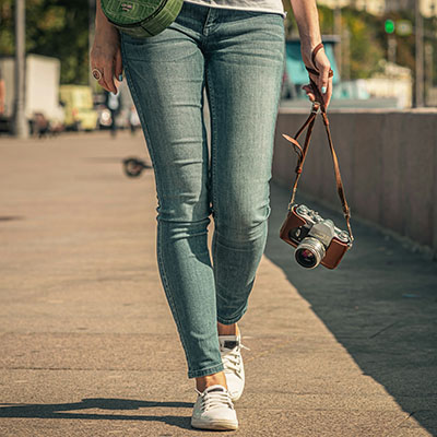 Woman walking with a camera.