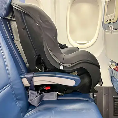 Car seat on airplane window seat.