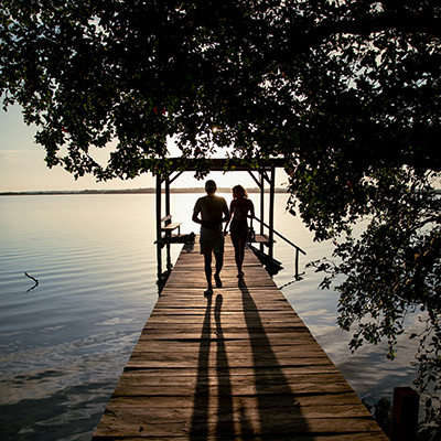 a couple walking on a dock
