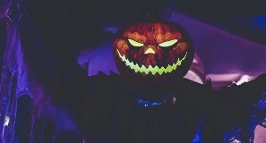 Halloween themed amusement park with creepy pumpkin man.