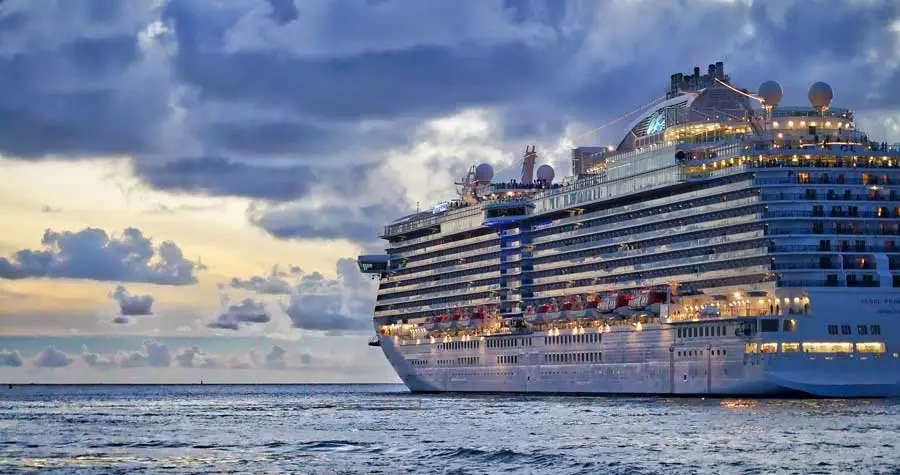 Cruise ship on water with cloudy sky