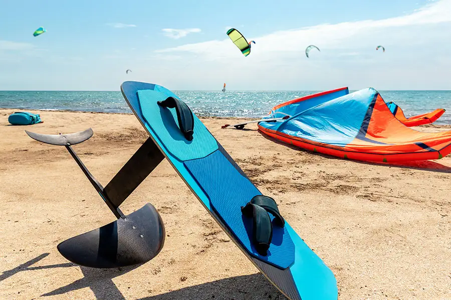 Electric surfboard (efoil) laying on the beach.