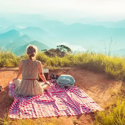 Woman has a cliffside picnic