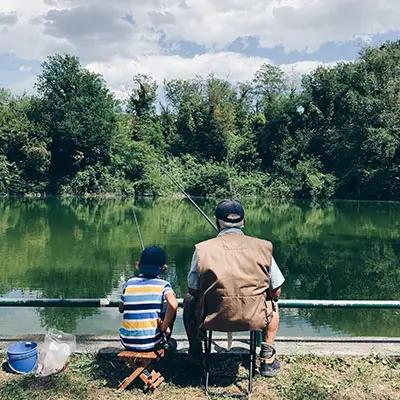Grandfather and grandson gone fishing in the lake.