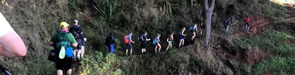 group-hiking-side-of-mountain