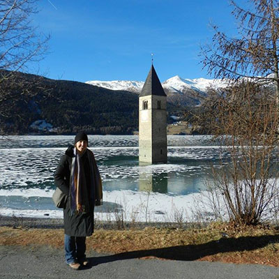 Woman standing in front of Lake Resia