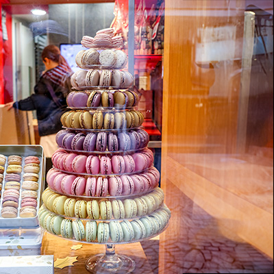 a tower of macaroons in a store window