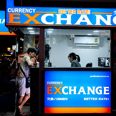 man standing near counter of currency exchange