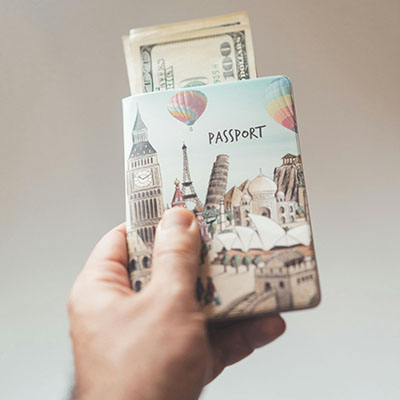 man holding a passport with money