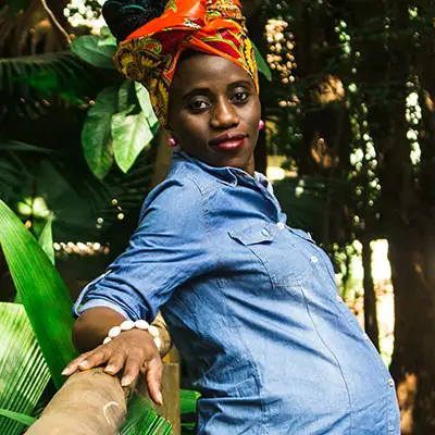 Pregnant woman wearing traditional African hairwrap.