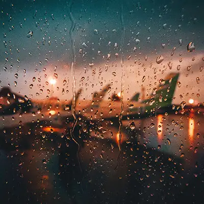 Rain falling down a window pane.