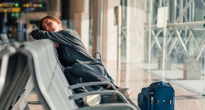 Woman sleeping in airport, flight was cancelled.