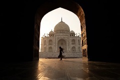 Woman dancing in front of Taj Mahal in India.