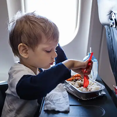 Toddler eating a snack on the plane
