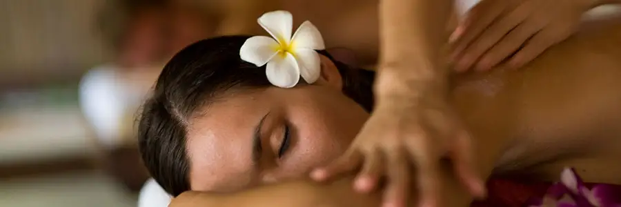 Woman getting a tropical massage.