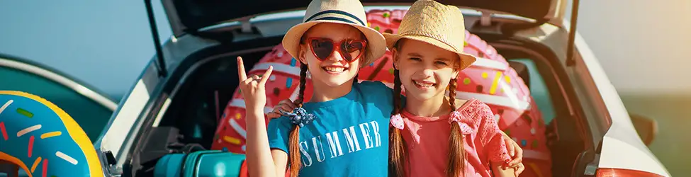 Twin girls on a summer road trip with family.