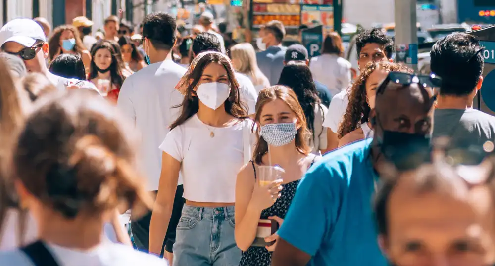 People wearing masks on a busy street