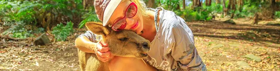 Young woman saving baby kangaroos in australia from a wildfire.