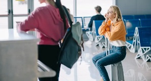 Young woman dazing off at airport waiting for flight.