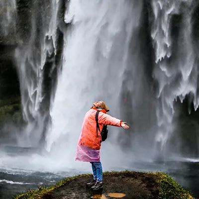 Woman standing in waterfalls.