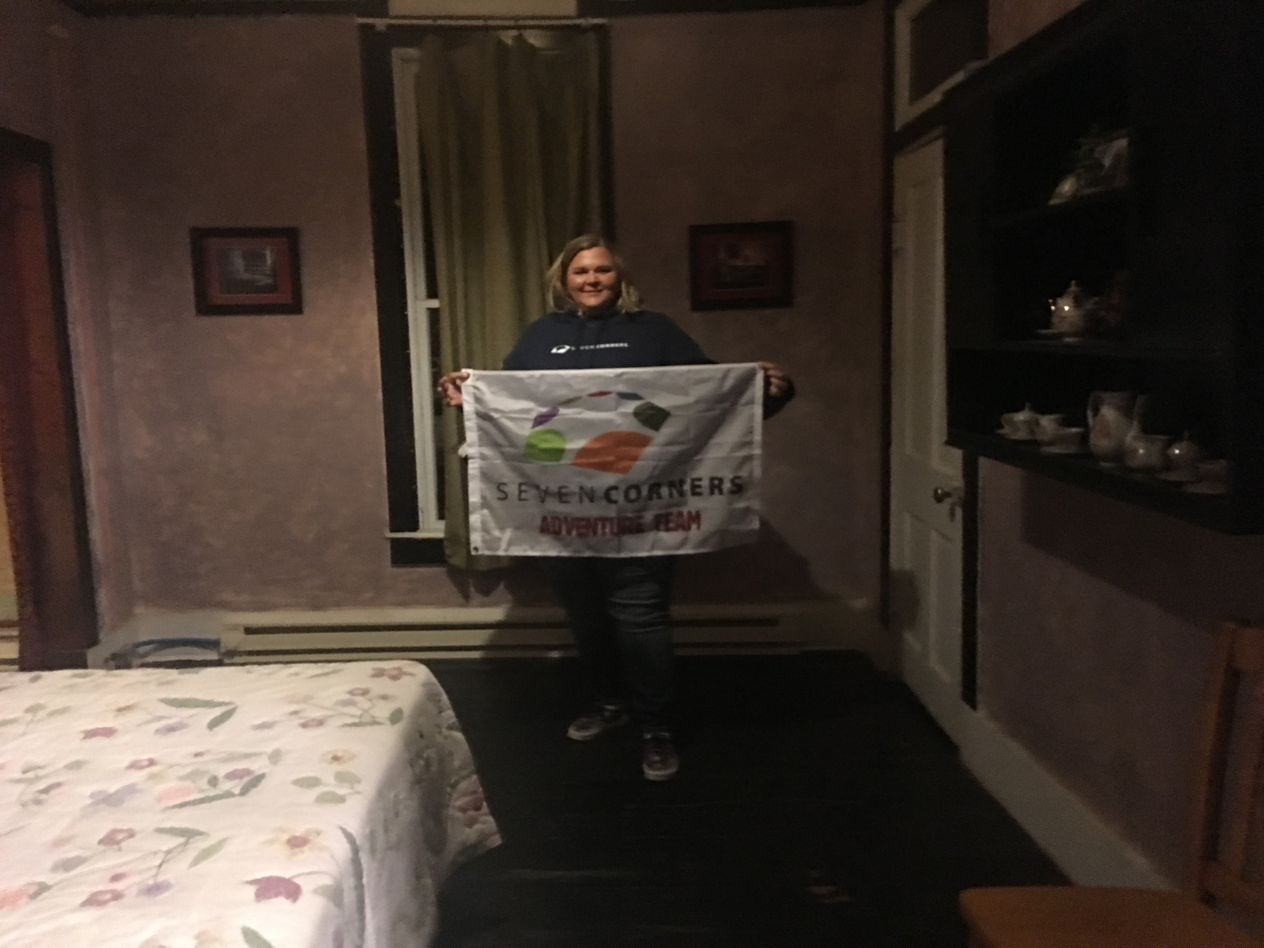 Amanda-poses-with-the-Seven-Corners-flag-in-haunted-hotel