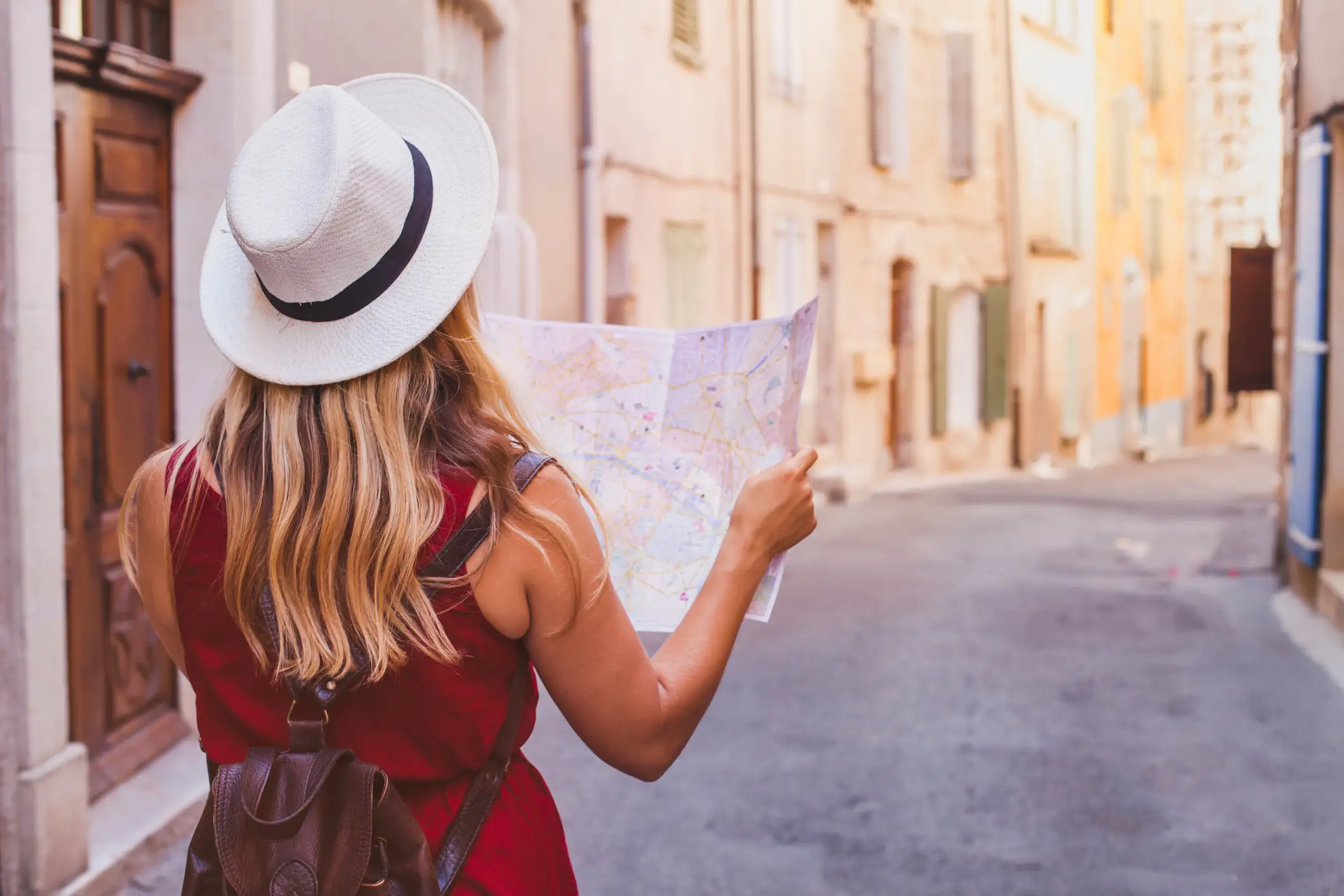 woman with travel insurance wanders streets with map