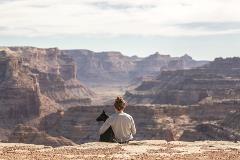 Dog-and-owner-sitting-on-edge-of-Grand-Canyon