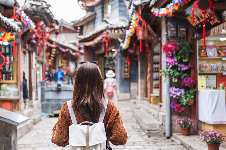 Young woman traveler walking at lijiang old town in China